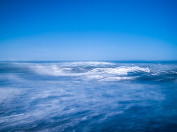 Scenic view of sea against blue sky