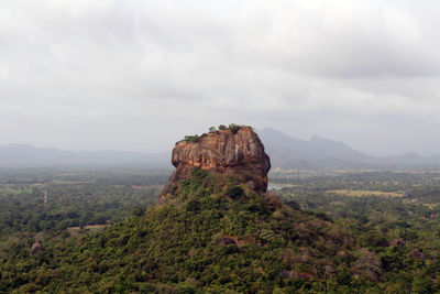 Rock formations on landscape against sky