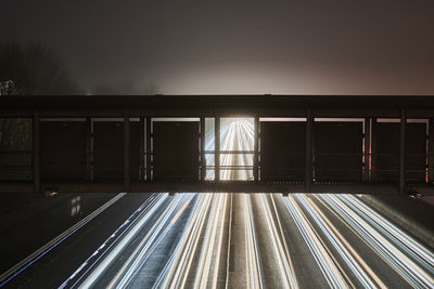 View of light trails on road at night