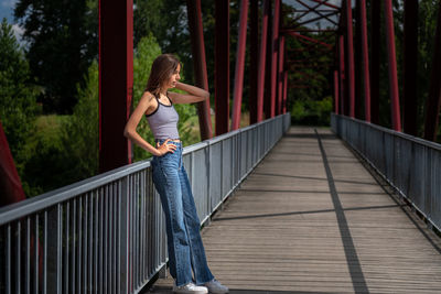 Woman standing on footbridge