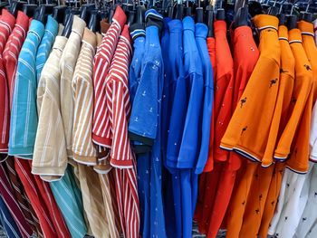 Multi colored clothes for sale in store