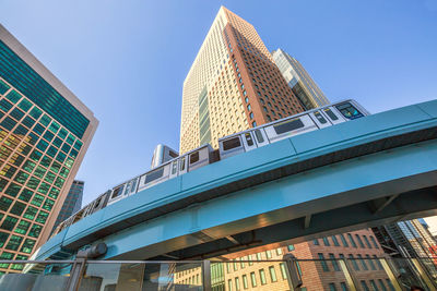 Low angle view of modern building against clear blue sky