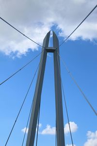 Low angle view of electricity pylon against blue sky