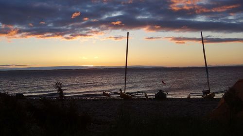 View of sea against cloudy sky during sunset