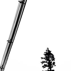 Low angle view of crane against clear sky