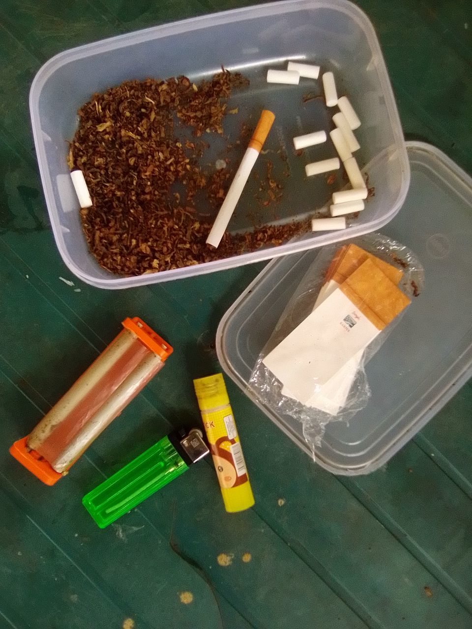 HIGH ANGLE VIEW OF CIGARETTE IN CONTAINER ON TABLE