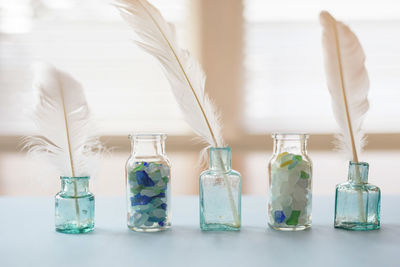 Close-up of bottles in jar on table