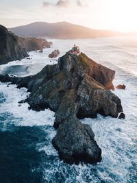 High angle view of sea splashing against rock formation 