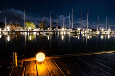 Sailboats in marina at night