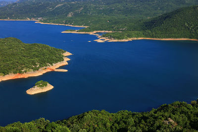 High angle view of sea by mountain