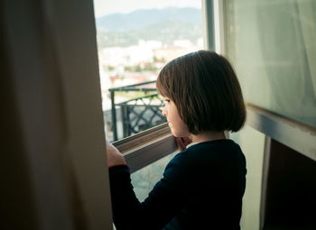 Little girl looking out the window