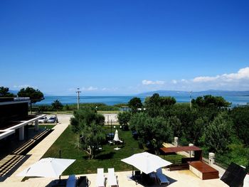 High angle view of swimming pool by building against sky