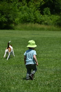 Rear view of two boys on field