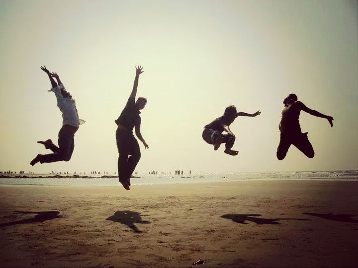 beach, mid-air, sea, leisure activity, lifestyles, sand, flying, full length, enjoyment, shore, fun, jumping, men, clear sky, vacations, togetherness, carefree, motion, silhouette