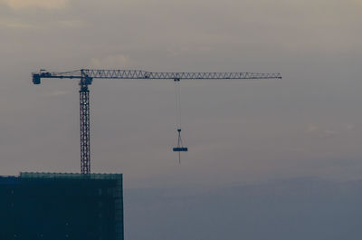 Crane against sky during sunset