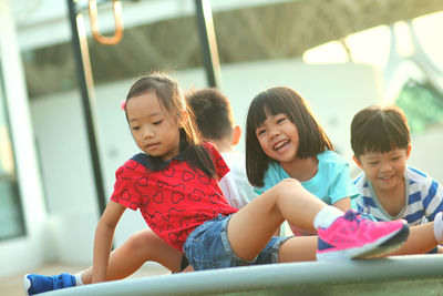 Happy friends playing at playground