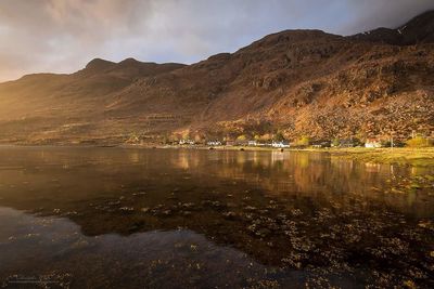 Scenic view of lake and mountains against sky
