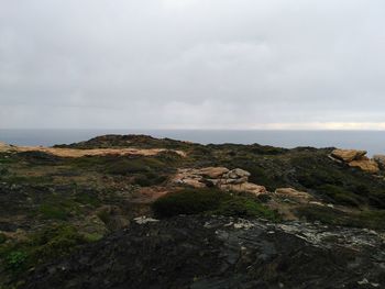 Scenic view of sea and rocks against sky