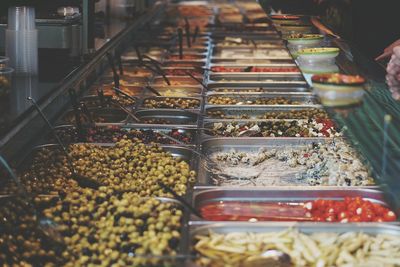 High angle view of olives in containers at store