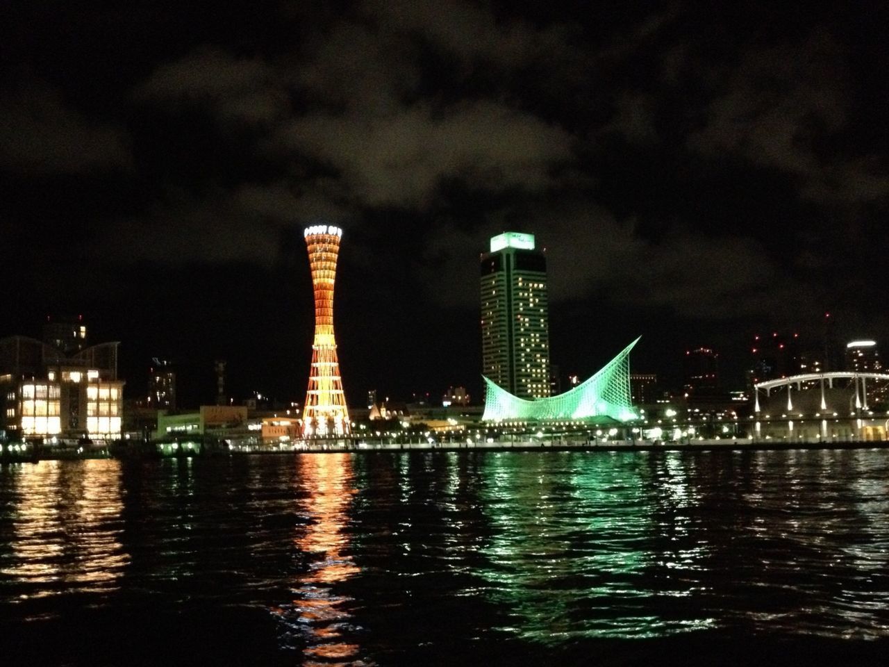 ILLUMINATED BUILDINGS AGAINST SKY AT NIGHT