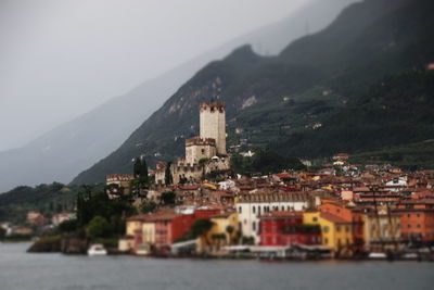 Townscape by sea against mountain in city