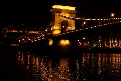 Low angle view of illuminated bridge at night