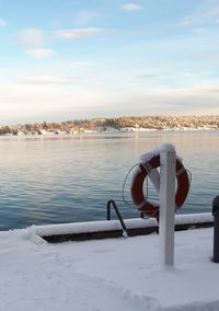 Scenic view of lake against sky during winter