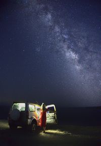  car on field at night - milkyway astrophotography