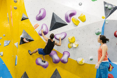 Woman climbing on wall