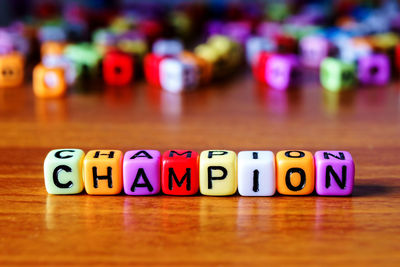 Close-up of text on multi colored toy blocks table