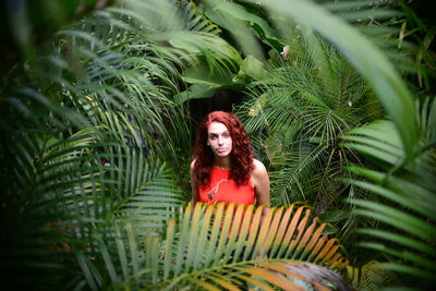 Portrait of young woman sorrounded by plants