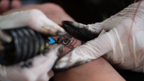 High angle view of woman hand with tattoo