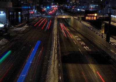 High angle view of light trails on road at night