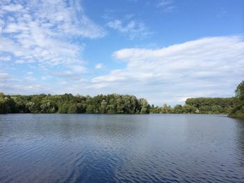 Scenic view of lake against cloudy sky