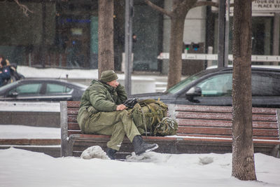 Man on snow covered city in winter