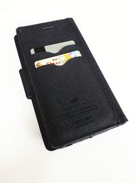 High angle view of black paper against white background