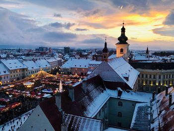 High angle view of buildings against sky during sunset in city