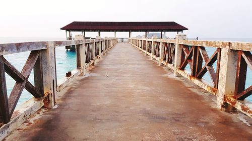 Pier over sea against clear sky