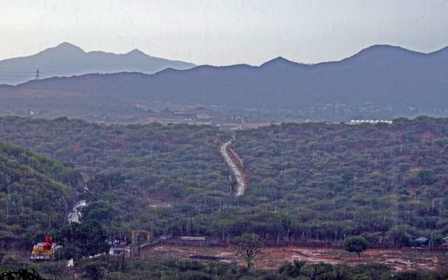 Scenic view of landscape and mountains against sky
