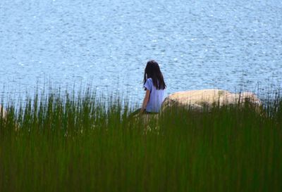 Rear view of woman standing on grass