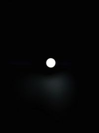 Low angle view of illuminated lights against dark sky