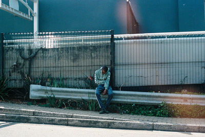 Man working on bridge in city