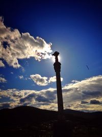 Low angle view of birds against blue sky