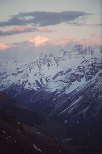 Scenic view of snowcapped mountains against sky during sunset