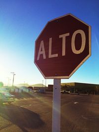 Road sign against blue sky