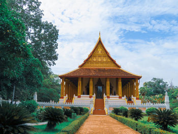 Temple by building against sky