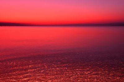 Scenic view of sea against romantic sky at sunset