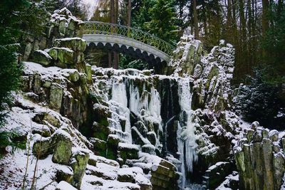 Scenic view of waterfall in forest during winter