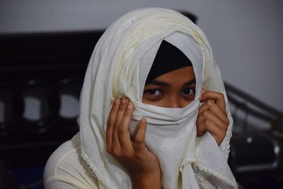 Portrait of woman covering face