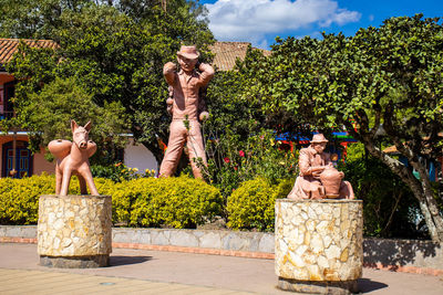 Statue against trees and plants